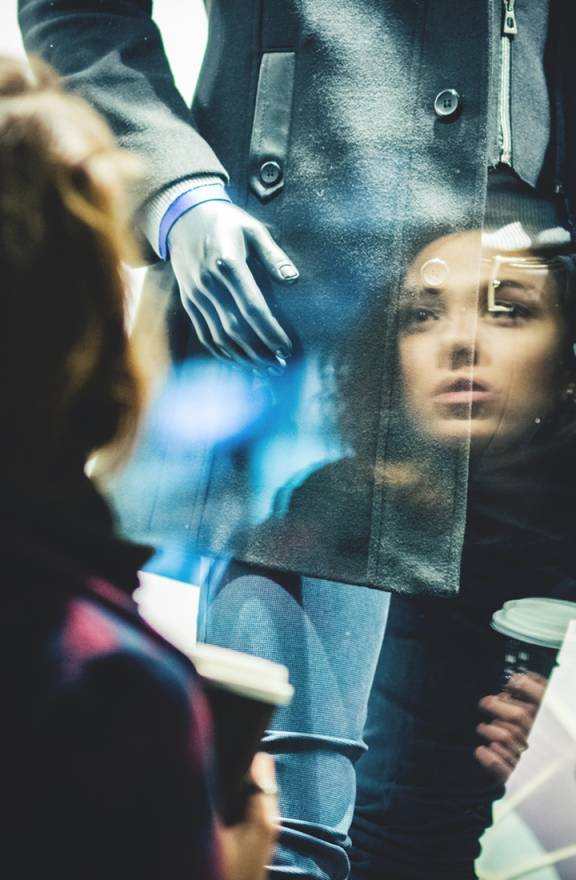Person-looking-at-an-outfit-in-a-window-shop